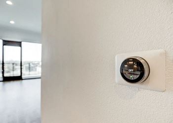 a white wall with a thermostat on it